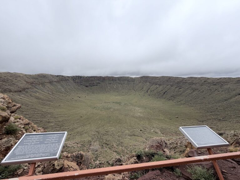 Overlook at Meteor Crater in Arizona with interpretive plaques describing the crater’s history and the family connected to the land.