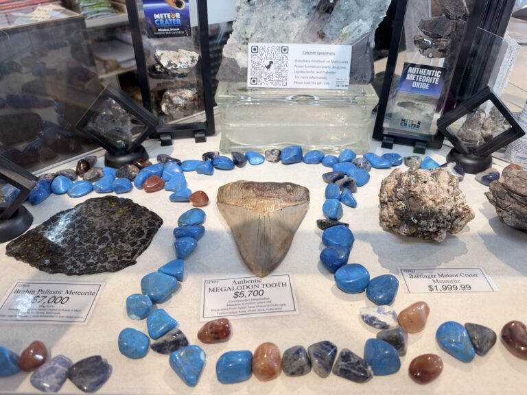 Display of colorful polished stones, mineral specimens, and souvenir items inside the Meteor Crater gift shop in Arizona.