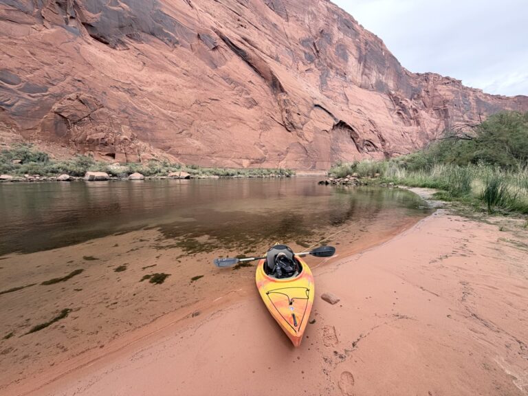 My kayak resting on a sandy bank beside the Colorado River