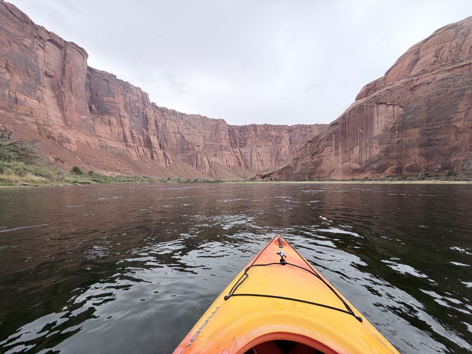 View from a kayak paddling the Colorado River through the red sandstone walls of Glen Canyon near Lees Ferry, Arizona